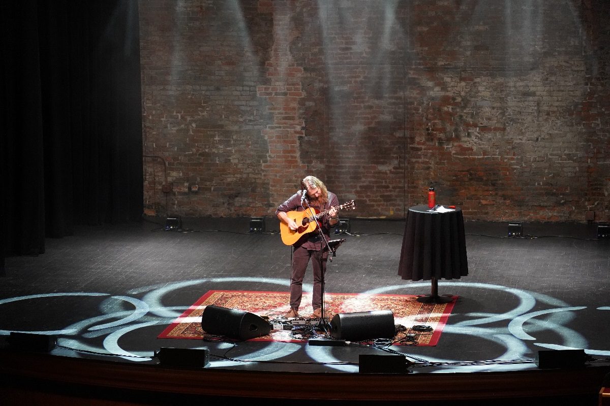 Singer with guitar on stage